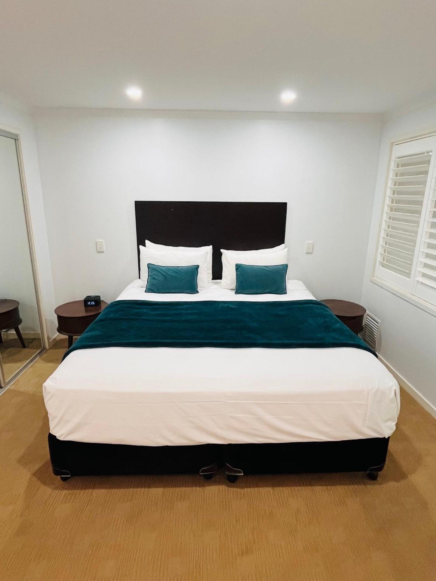 At Marina Shores Airlie Beach Εξωτερικό φωτογραφία A bed with a bed runner